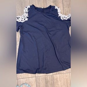 Pretty navy cold shoulder top. With beautiful white lace detail on sleeves.